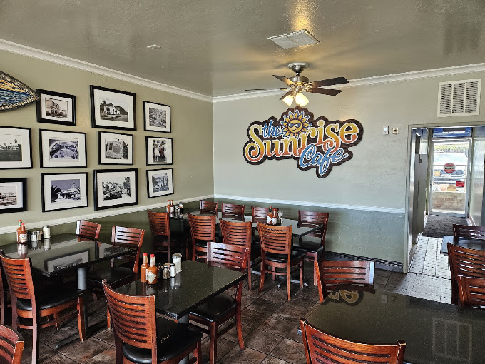 The Sunrise Cafe dining room, with a wall of vintage San Clemente photos and the hand-painted sun mural
